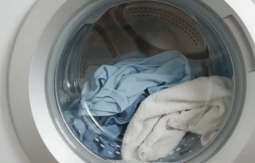 Laundry tumbling inside a front-loading drum