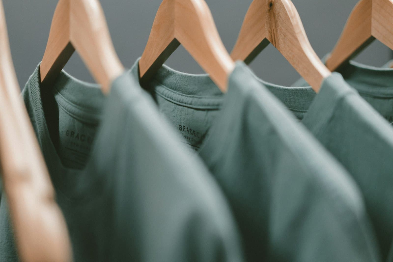 Freshly cleaned garments hanging on wooden hangers